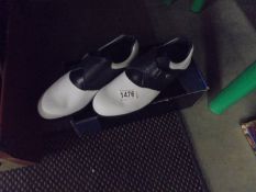 A boxed pair of new Footjoy golf shoes, size 7.