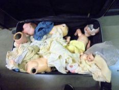 A large suitcase containing a quantity of a/f vintage dolls.