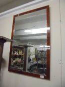 A large walnut framed bevel edged mirror.