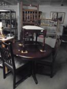 A good quality circular oak dining table and a set of four oak chairs.
