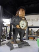 A cast iron figural automata clock with moving eyes.