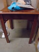 A darkwood stained side table.