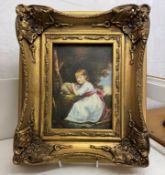 A gilt framed over painted print of girl with rabbit