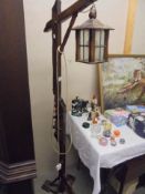 A wooden floor lamp in the style of a lantern.