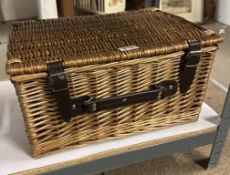 A wicker picnic basket in good condition (no contents).