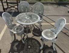A metal garden table with 4 chairs