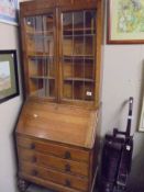 A circa 1930's oak bureau bookcase with leaded glass doors.