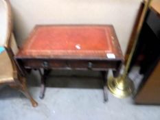 A drop side coffee table with leather inset and two drawers.