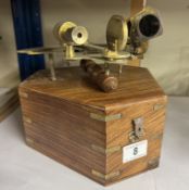 A brass sextant in teak box