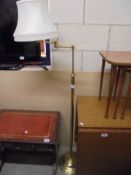 An adjustable brass effect floor lamp.