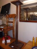 An Edwardian mahogany torchere/pot stand on reeded column.
