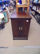 A mahogany two door cabinet.