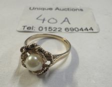 A vintage cultured pearl ring fashioned as a rose bud with cultured pearl to centre in a textured