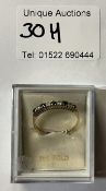 A 9ct gold ring set with blue & white stones 9in total