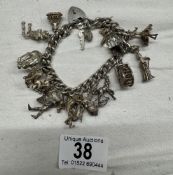 A good silver charm bracelet with fifteen charms, total weight 98 grams.