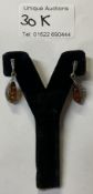 A pair of silver set amber ear pendants fretwork mount