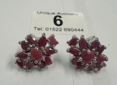 A pair of silver & ruby cluster earrings