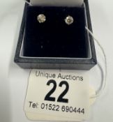 A pair of 14ct white gold diamond stud earrings of 63 points
