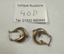 A pair of hoop earrings fashioned as dolphins in 9ct gold stamped