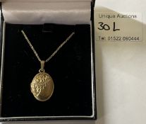 A 9ct gold long chain and locket (opening)
