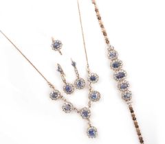 A blue and white sapphire parure, comprising: a necklace formed of five clusters in low carat