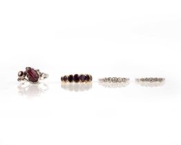 A group of four rings, comprising: an amethyst eight stone ring, in closed-back yellow gold setting,