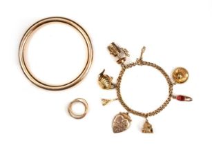 A collection of gold jewellery, comprising: a charm bracelet of curb linking suspending seven charms