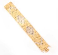 A two-colour gold strap bracelet, mid 20th century, the fancy links arranged to form white gold