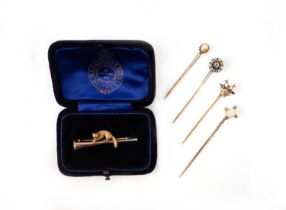 A collection of stickpins and a brooch, comprising: a citrine and seed pearl stickpin, the