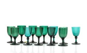 A group of twelve green wine glasses,
