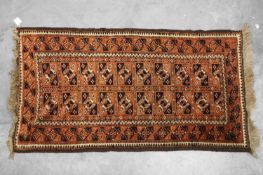 A red ground Baluch rug,