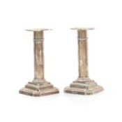 A pair of silver candlesticks,