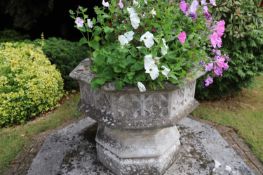A modern composite stone octagonal font,