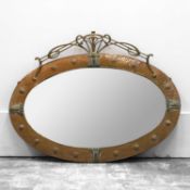 A copper and brass Arts and Crafts oval wall mirror,