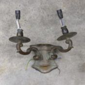 A patinated bronze two branch wall light,