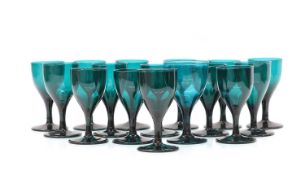 A composed set of sixteen green wine glasses,