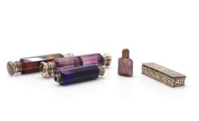 A collection of silver-mounted glass scent bottles,