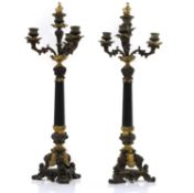A pair of paternated gilt and bronze Regency style candlabra,