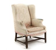 A George III mahogany wing armchair,