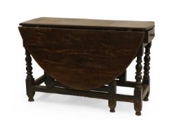 An oak gateleg table and six Lancashire type chairs,