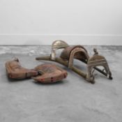 A wood and brass camel saddle,