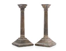 A pair of silver Corinthian column candlesticks,
