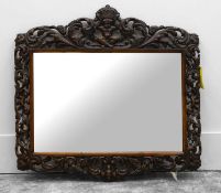 A carved oak wall mirror,