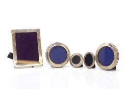 A group of five silver photograph frames,