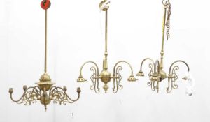 A group of three brass chandeliers,