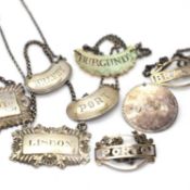 A group of four silver spirit labels,