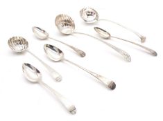A collection of silver serving spoons and ladles,