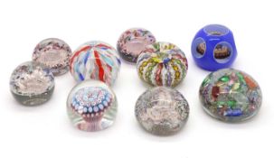 A group of glass paperweights,