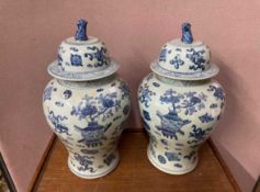 A pair of Chinese blue and white vases and covers,
