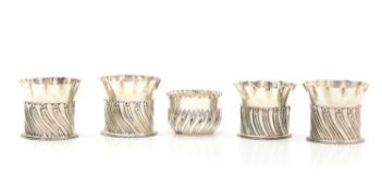 A set of four silver bottle coasters or holders,